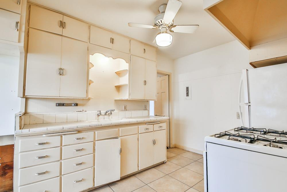 2318 29th Street Lubbock, TX 79411 - Photo 8 of 32 a bathroom with a sink vanity granite and a mirror