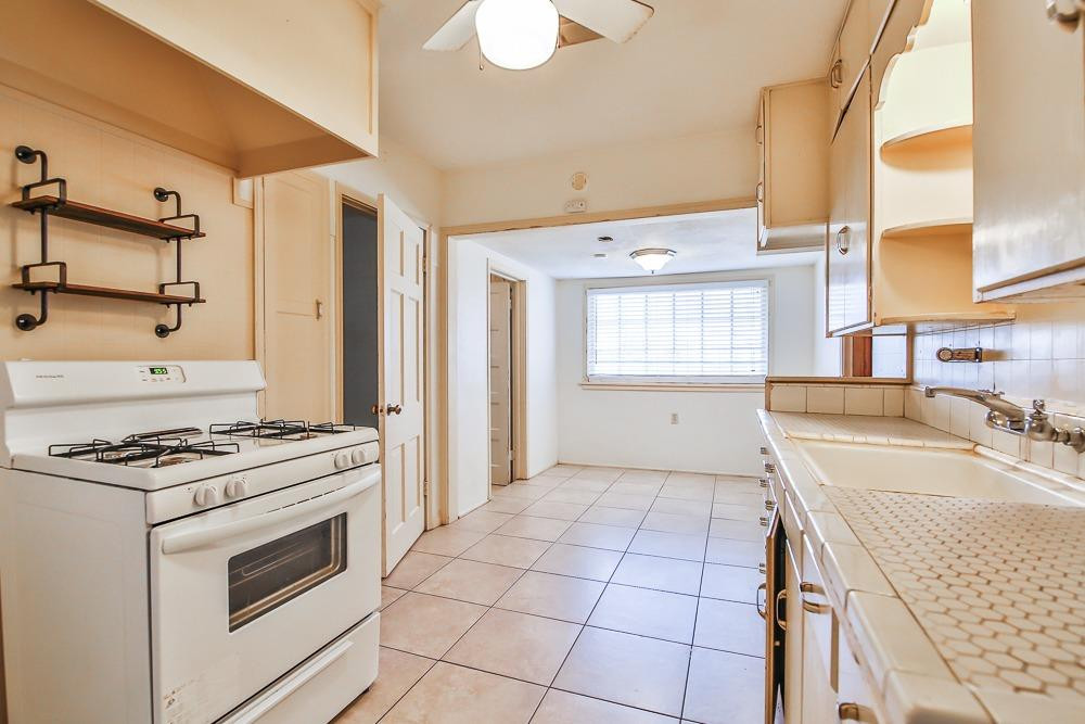 2318 29th Street Lubbock, TX 79411 - Photo 9 of 32 a kitchen with a stove a sink and a refrigerator