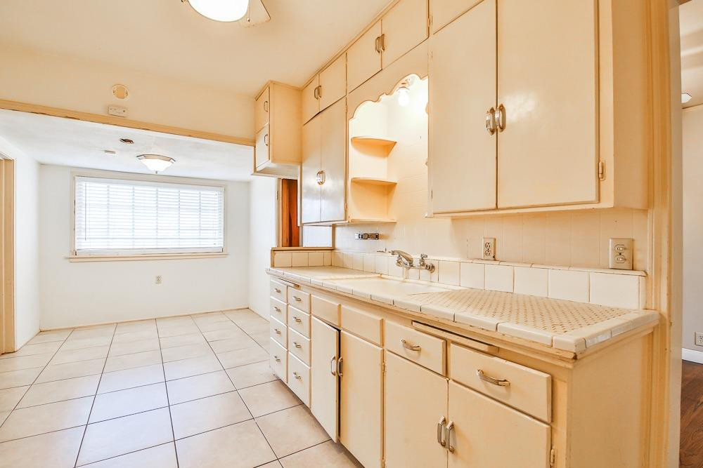2318 29th Street Lubbock, TX 79411 - Photo 10 of 32 a bathroom with a sink a vanity and a mirror