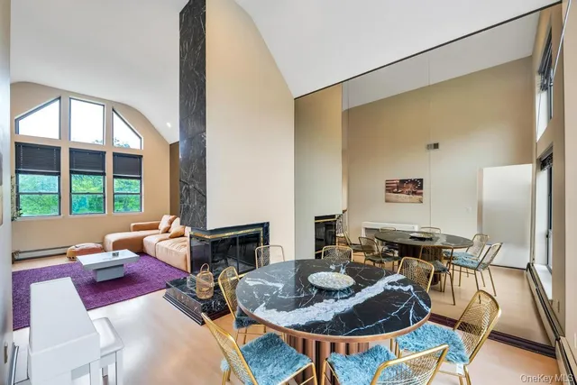 a living room with furniture and a floor to ceiling window