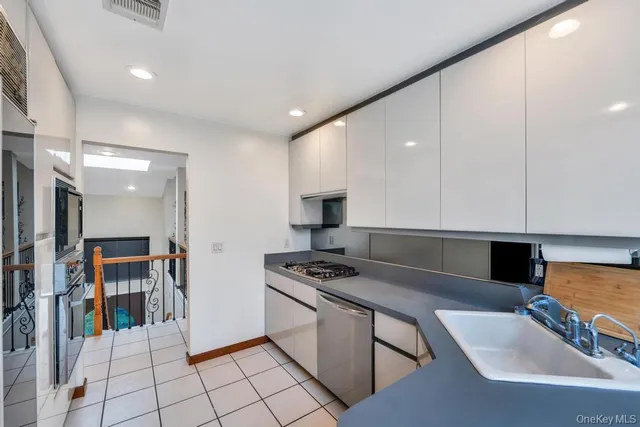 a kitchen with stainless steel appliances granite countertop a sink and cabinets