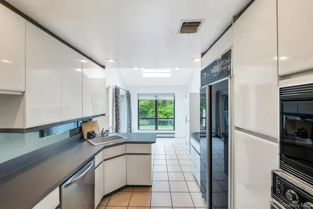 a kitchen with a sink and a refrigerator