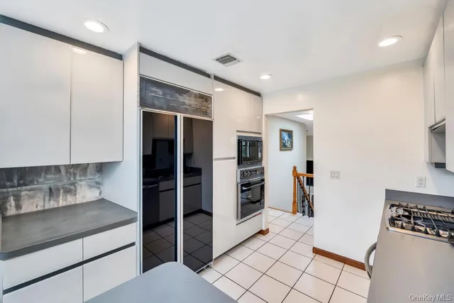 a kitchen with stainless steel appliances granite countertop a refrigerator and a stove