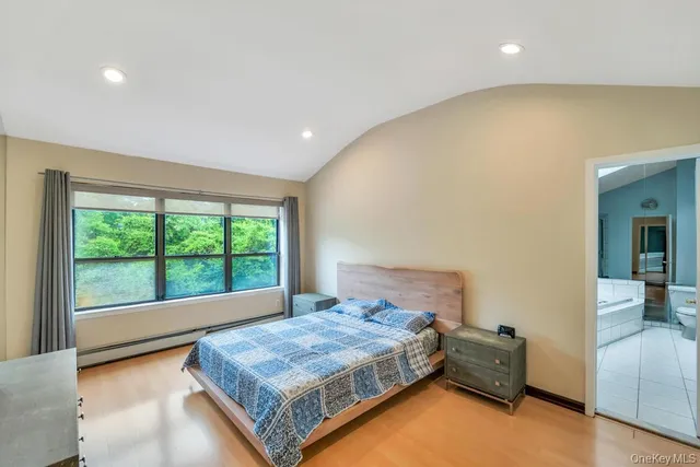 a spacious bedroom with a bed and a large window