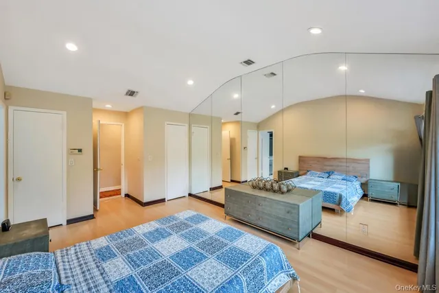 a spacious bedroom with a bed and a couch