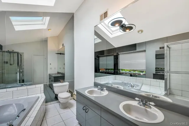 a bathroom with a sink double vanity and a toilet