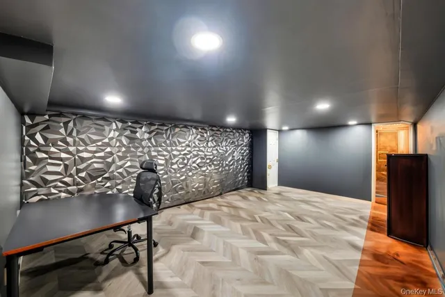 a spacious bedroom with a bed and lamp