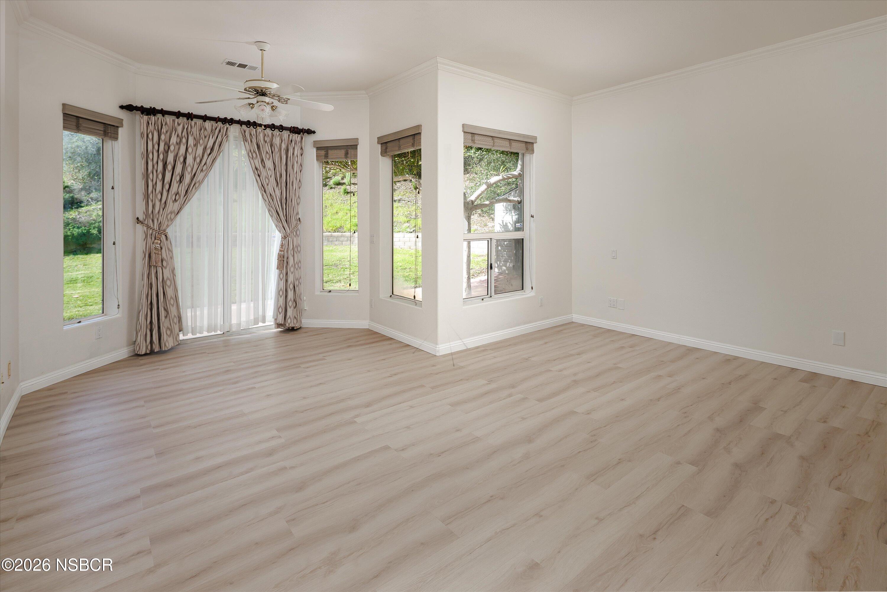 2655 Adobe Falls Road Lompoc, CA 93436 - Photo 25 of 51 an empty room with wooden floor and windows