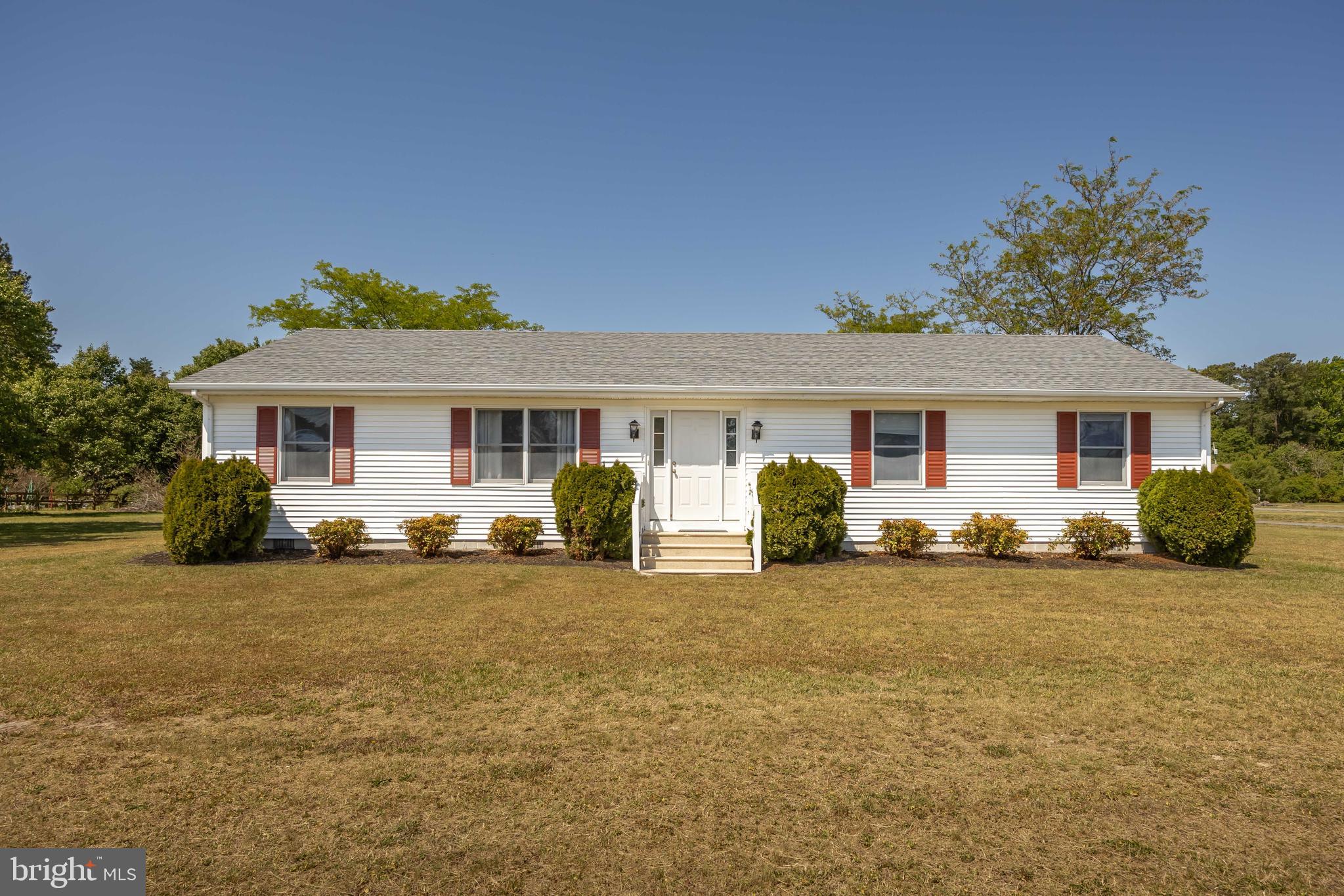 9830 Sharptown Road Mardela Springs, MD 21837 - Photo 2 of 51 front view of a house with a patio