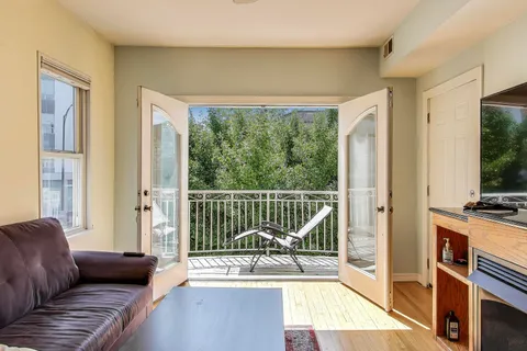 a living room with furniture and a floor to ceiling window