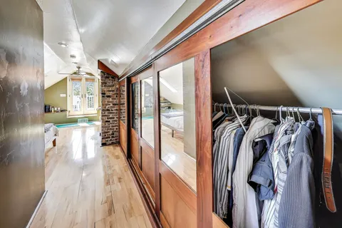 a view of walk in closet with clothes and shoes