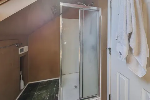 a bathroom with a glass shower door