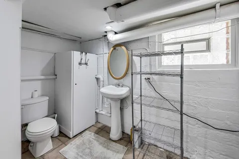a bathroom with a toilet a sink and shower