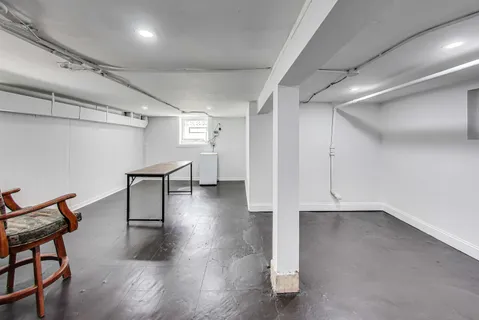 an empty room with wooden floor and furniture