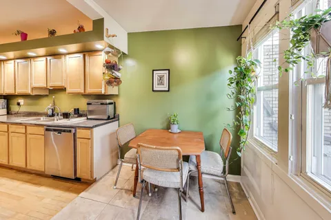 a view of a dining room with furniture and a window