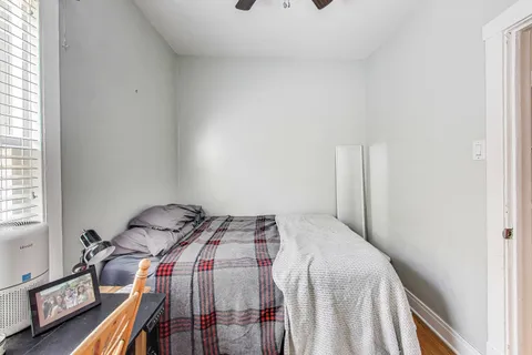 a bedroom with a bed and a window