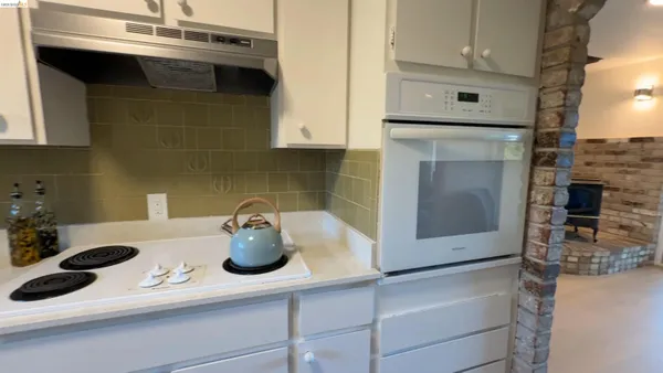 a kitchen with a sink and a stove top oven
