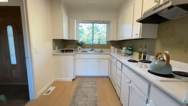 a kitchen with a sink stove and cabinets