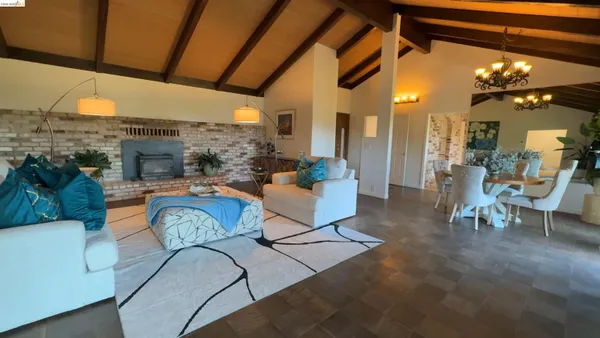 a living room with fireplace furniture and a floor to ceiling window