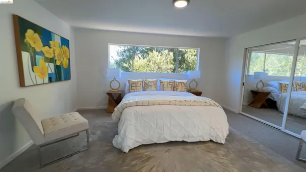 a bedroom with a bed and a couch