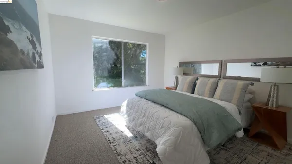 a bedroom with a bed and window