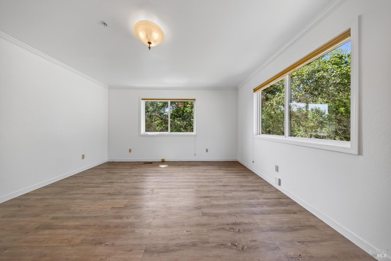 10 Lockton Lane Novato, CA 94945 - Photo 52 of 68 Lower-level bedroom or bonus room with large windows, suitable for guests, au pair quarters, fitness, or private workspace.