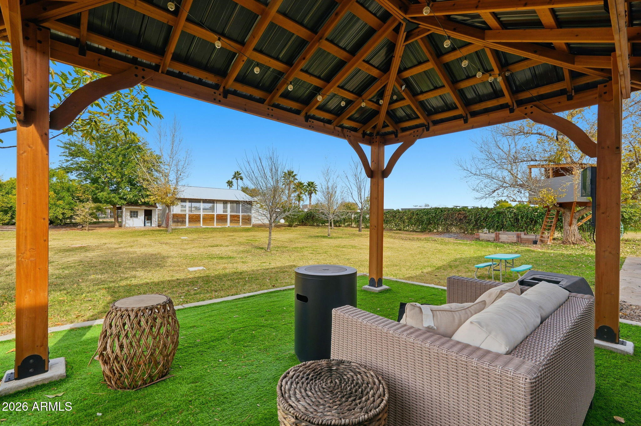 2858 East Redfield Road Gilbert, AZ 85234 - Photo 45 of 60 a view of a patio with lawn chairs next to a yard