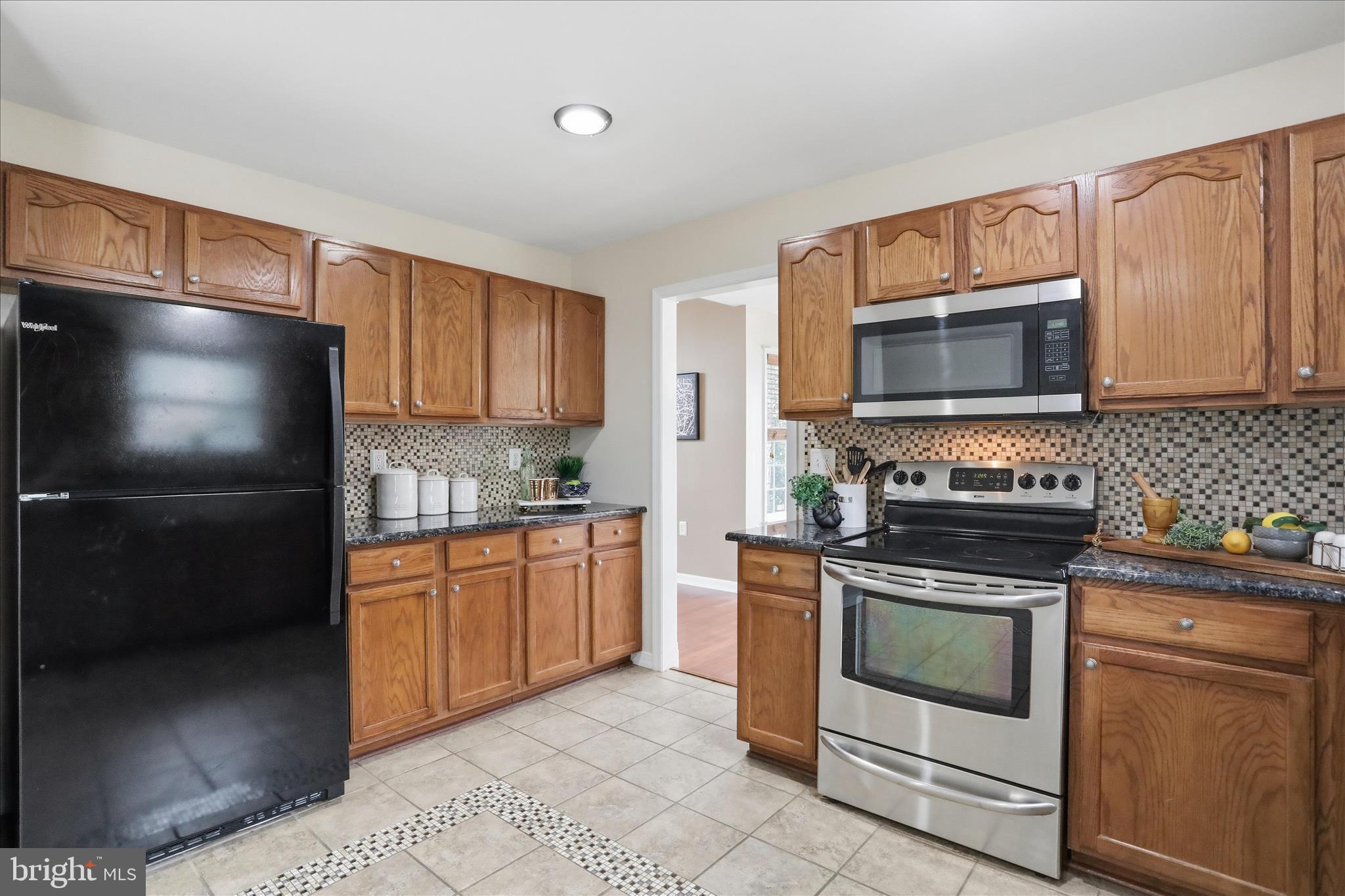 88 Grassy Meadow Road Charles Town, WV 25414 - Photo 11 of 44 a kitchen with stainless steel appliances granite countertop a stove microwave and refrigerator