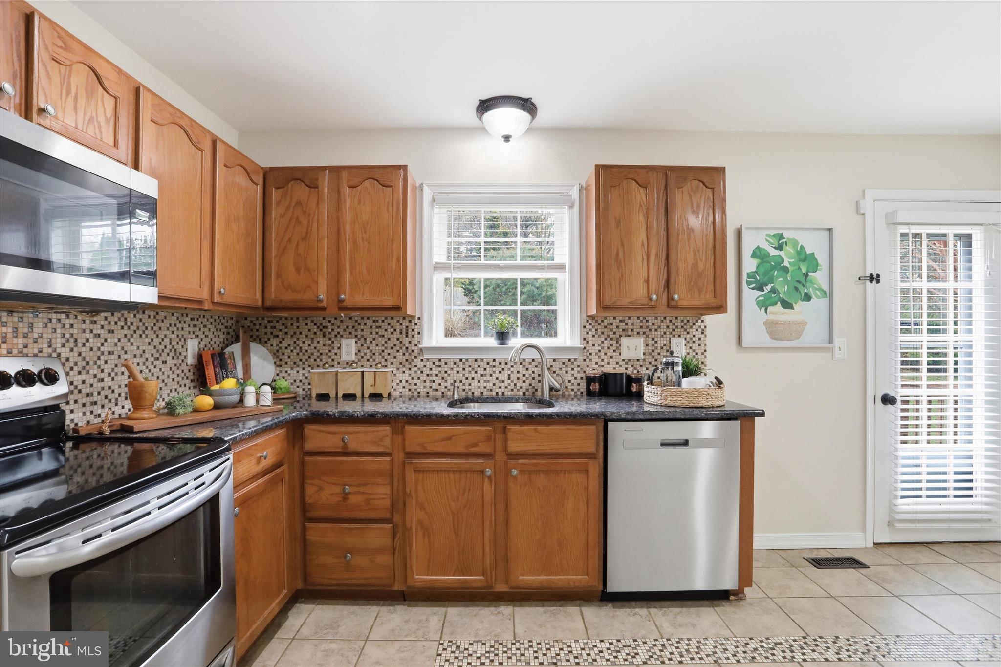 88 Grassy Meadow Road Charles Town, WV 25414 - Photo 12 of 44 a kitchen with stainless steel appliances granite countertop a sink stove and cabinets