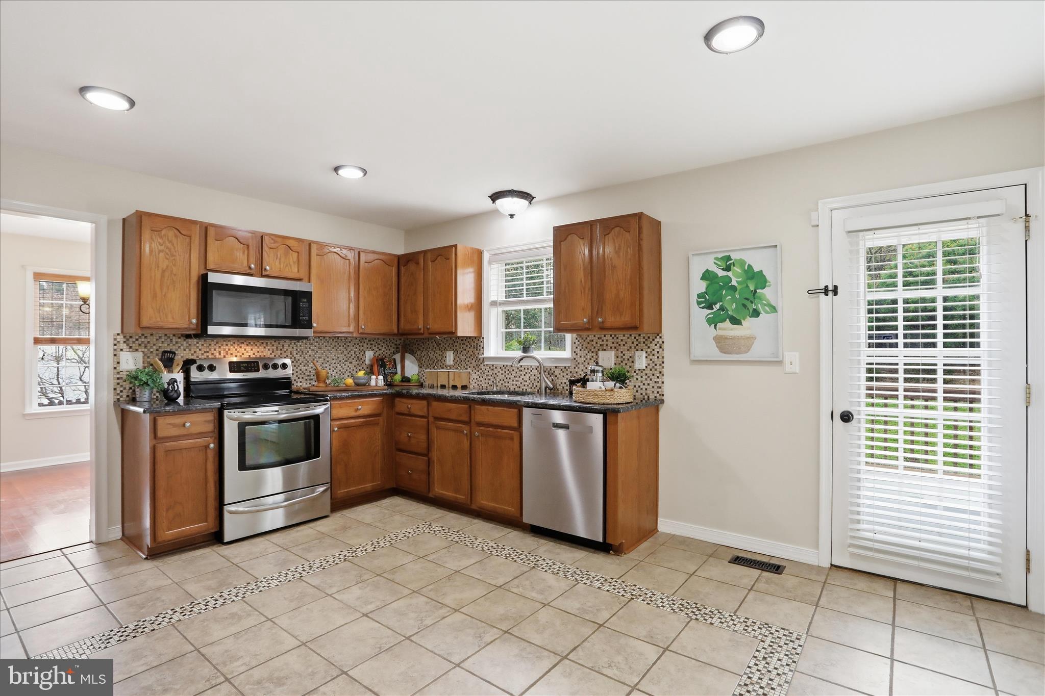 88 Grassy Meadow Road Charles Town, WV 25414 - Photo 13 of 44 a kitchen with granite countertop a stove a sink and a microwave