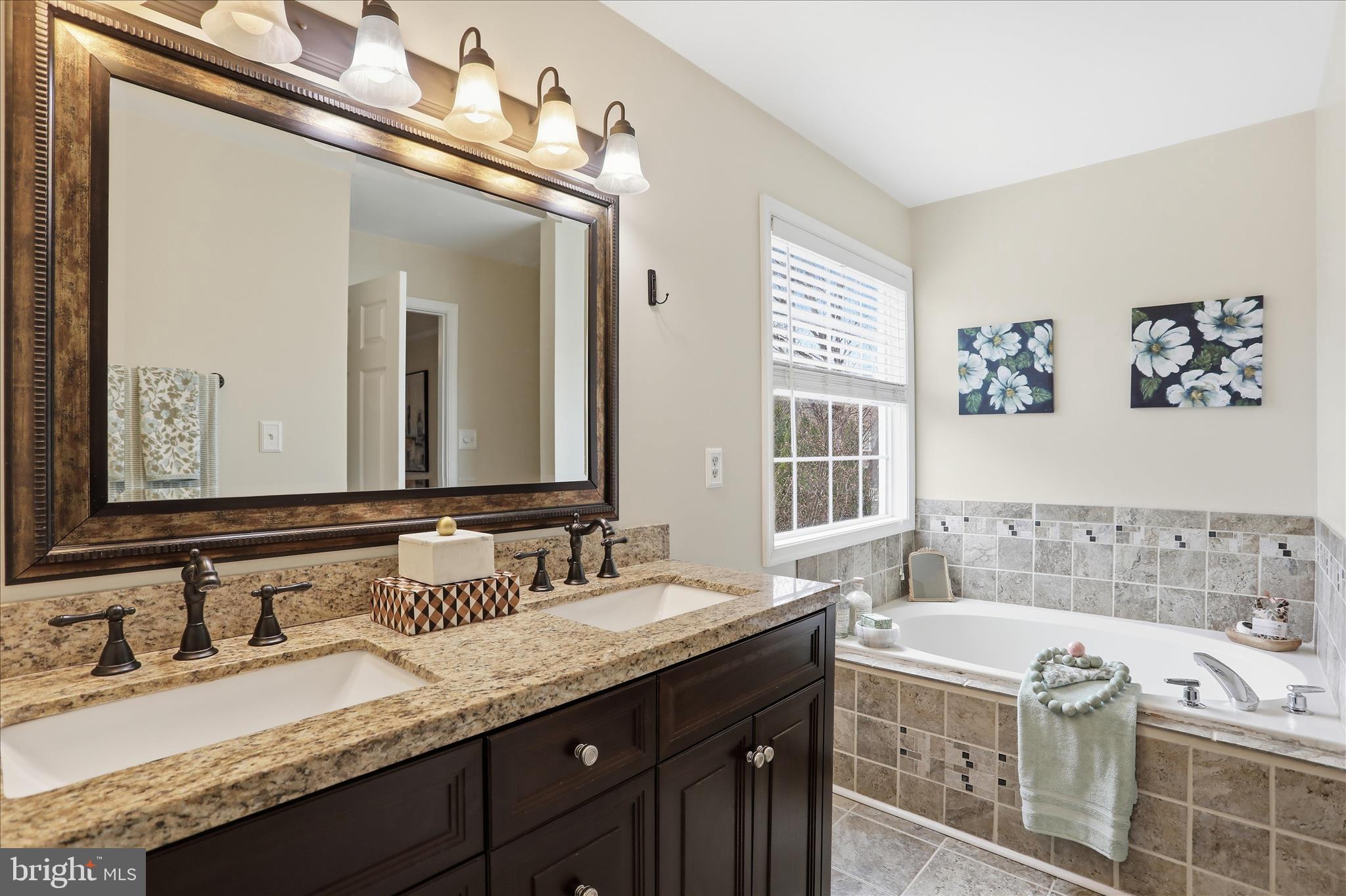 88 Grassy Meadow Road Charles Town, WV 25414 - Photo 18 of 44 a spacious bathroom with a granite countertop tub sink and mirror