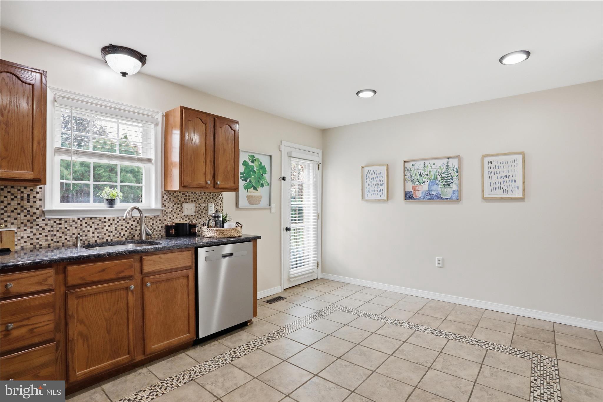 88 Grassy Meadow Road Charles Town, WV 25414 - Photo 10 of 44 a kitchen with stainless steel appliances granite countertop a sink and a stove top oven