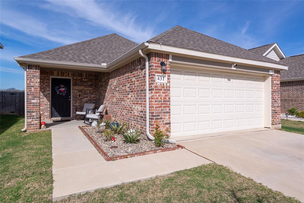 431 Woodhouse Way Everman, TX 76140 - Photo 1 of 30 a front view of a house with garden