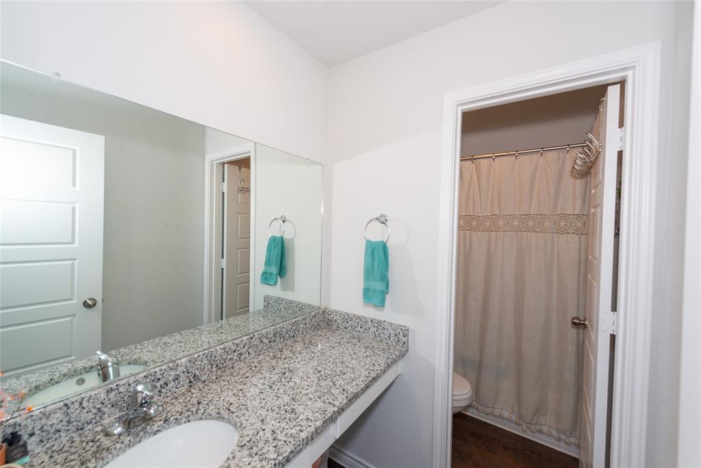 431 Woodhouse Way Everman, TX 76140 - Photo 14 of 30 a bathroom with a granite countertop sink and a mirror