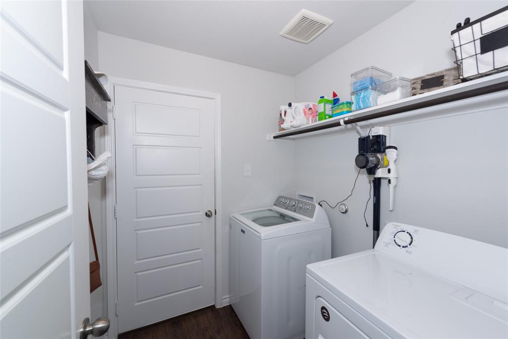 431 Woodhouse Way Everman, TX 76140 - Photo 19 of 30 a view of storage and utility room with washer and dryer