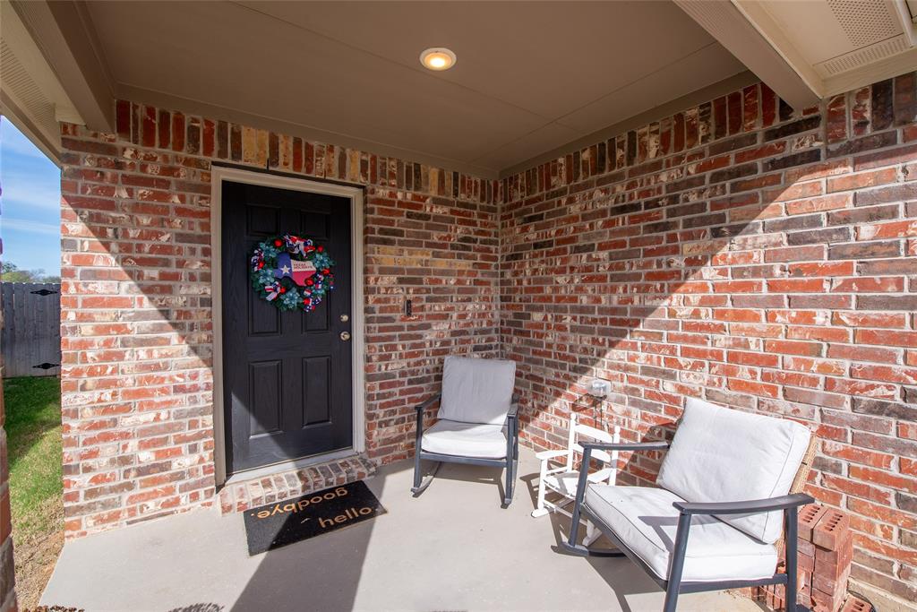 431 Woodhouse Way Everman, TX 76140 - Photo 2 of 30 Property entrance with brick siding and covered porch