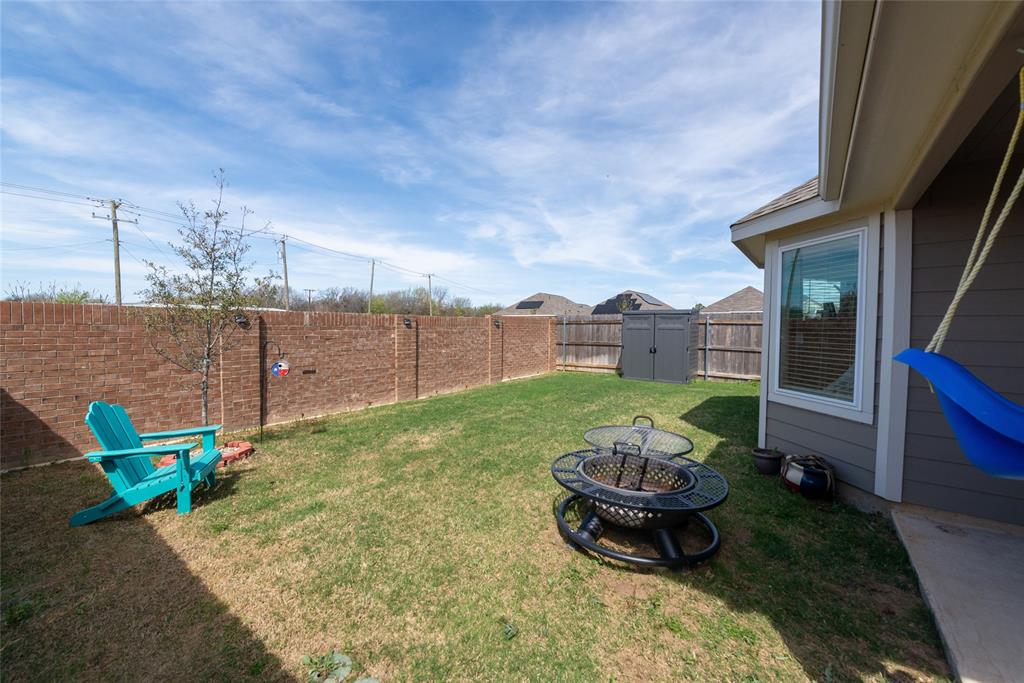 431 Woodhouse Way Everman, TX 76140 - Photo 23 of 30 a brick house with table and chairs in front of it