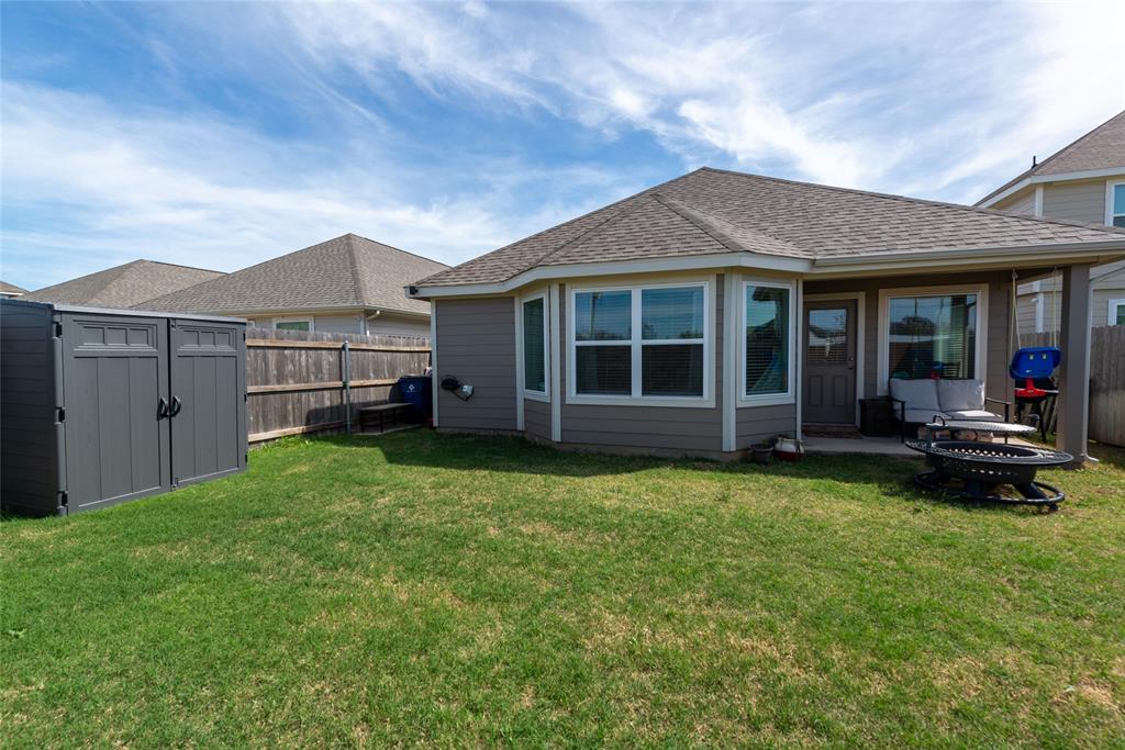 431 Woodhouse Way Everman, TX 76140 - Photo 26 of 30 a view of a house with a garden and yard