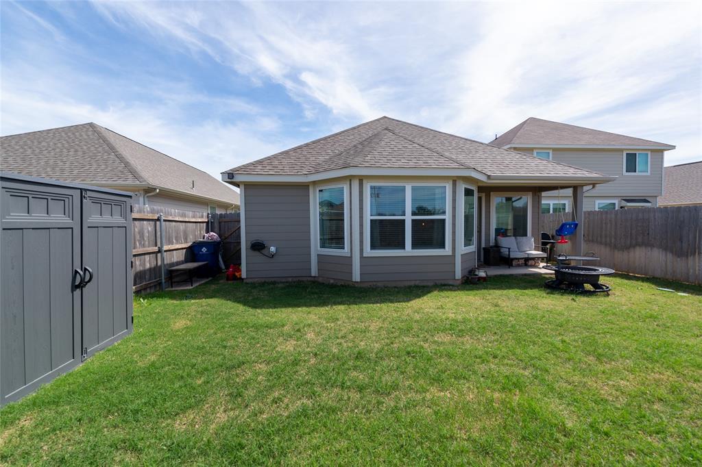 431 Woodhouse Way Everman, TX 76140 - Photo 27 of 30 a view of a house with backyard porch and garden