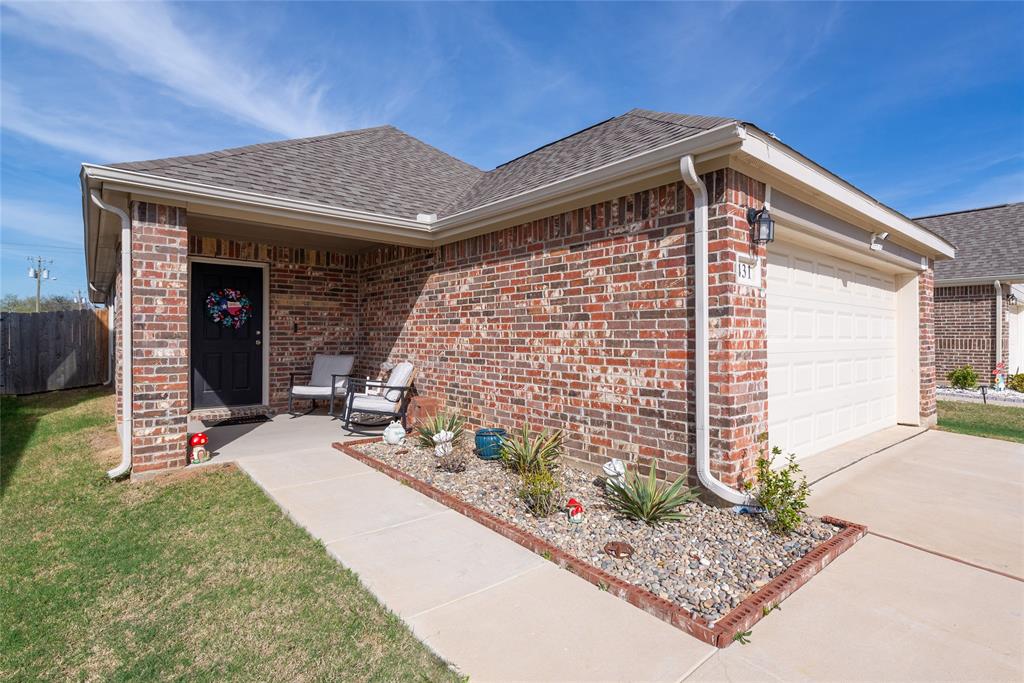 431 Woodhouse Way Everman, TX 76140 - Photo 5 of 30 a front view of a house with garden