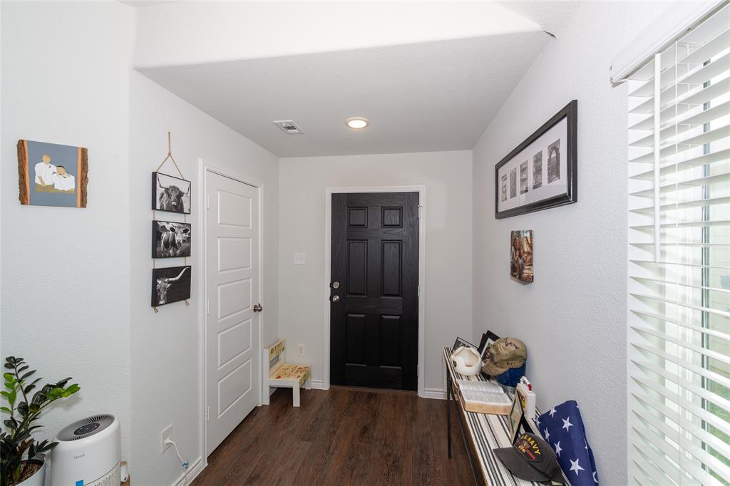 431 Woodhouse Way Everman, TX 76140 - Photo 6 of 30 a hallway with front door wooden floor and closet