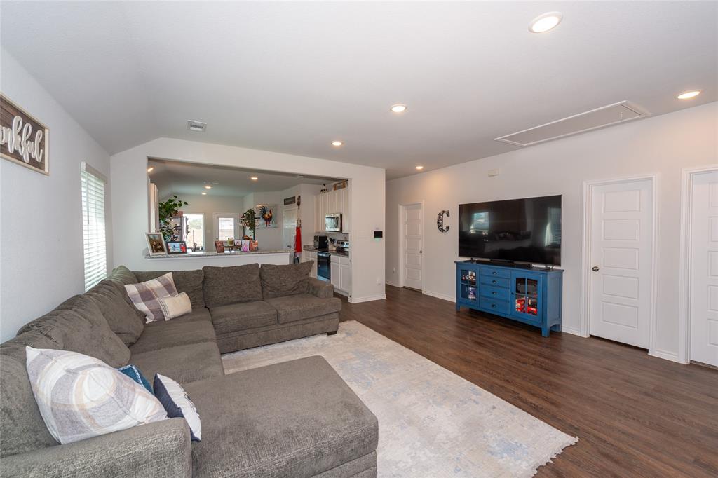 431 Woodhouse Way Everman, TX 76140 - Photo 8 of 30 a living room with furniture and a flat screen tv