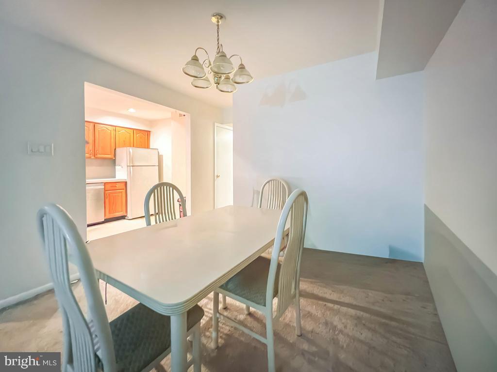10843 Academy Road Philadelphia, PA 19154 - Photo 10 of 30 a view of a dining room with furniture and chandelier