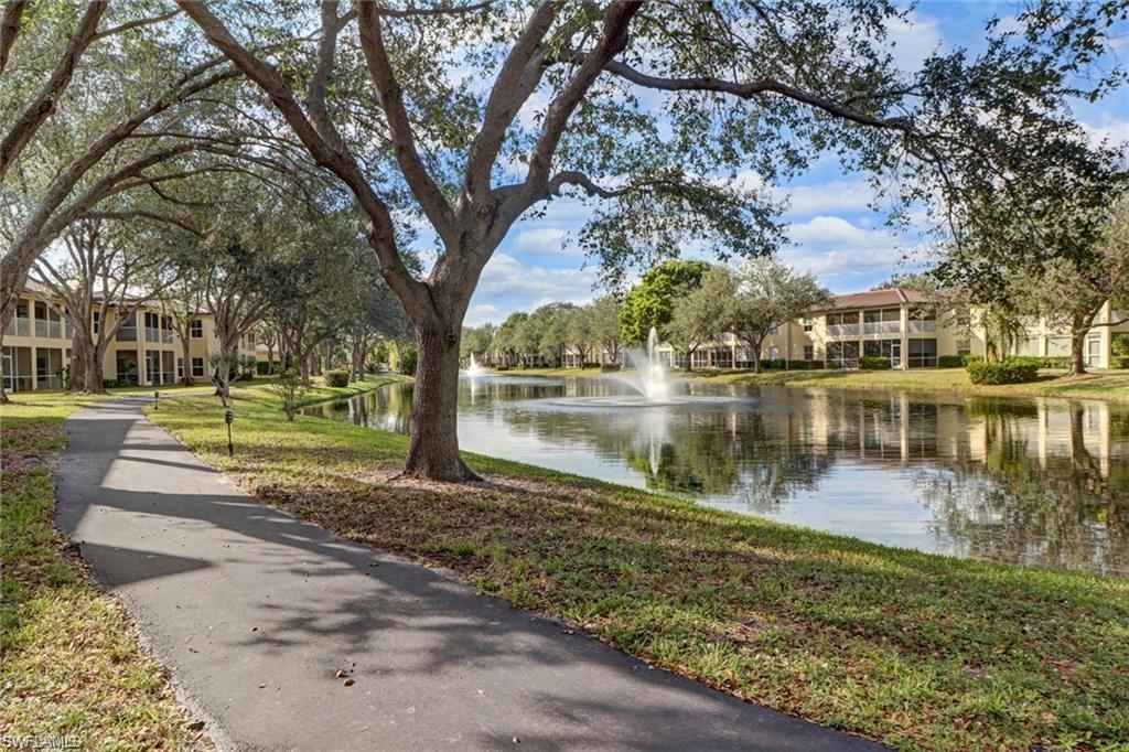300 Diamond Circle, Unit 302 Naples, FL 34110 - Photo 11 of 14 a view of a lake with a house
