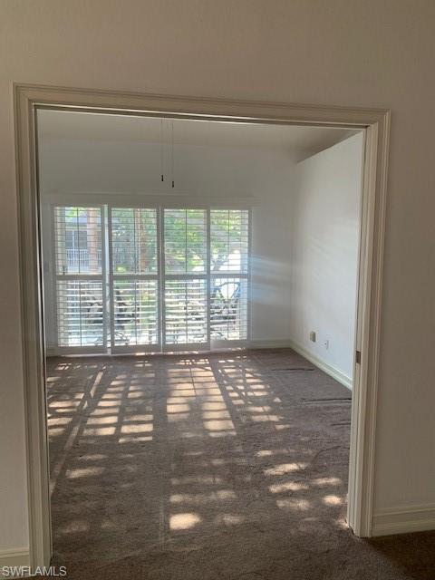 300 Diamond Circle, Unit 302 Naples, FL 34110 - Photo 4 of 14 a view of an empty room with a window