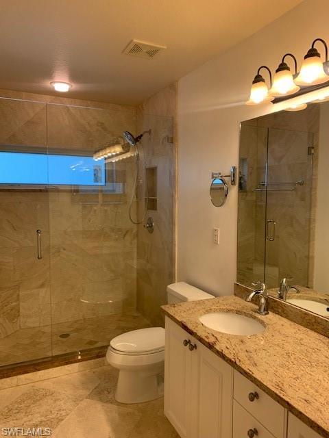 300 Diamond Circle, Unit 302 Naples, FL 34110 - Photo 5 of 14 a bathroom with a granite countertop sink toilet and shower