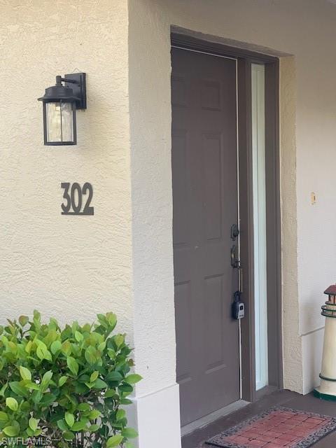 300 Diamond Circle, Unit 302 Naples, FL 34110 - Photo 7 of 14 a view of a hallway with interior of the house
