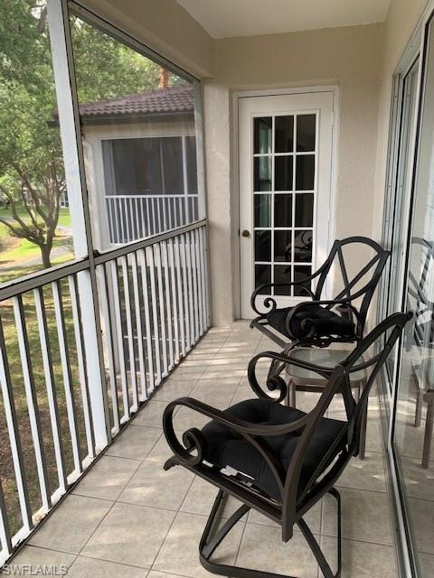 300 Diamond Circle, Unit 302 Naples, FL 34110 - Photo 10 of 14 a view of a chairs and table in the balcony