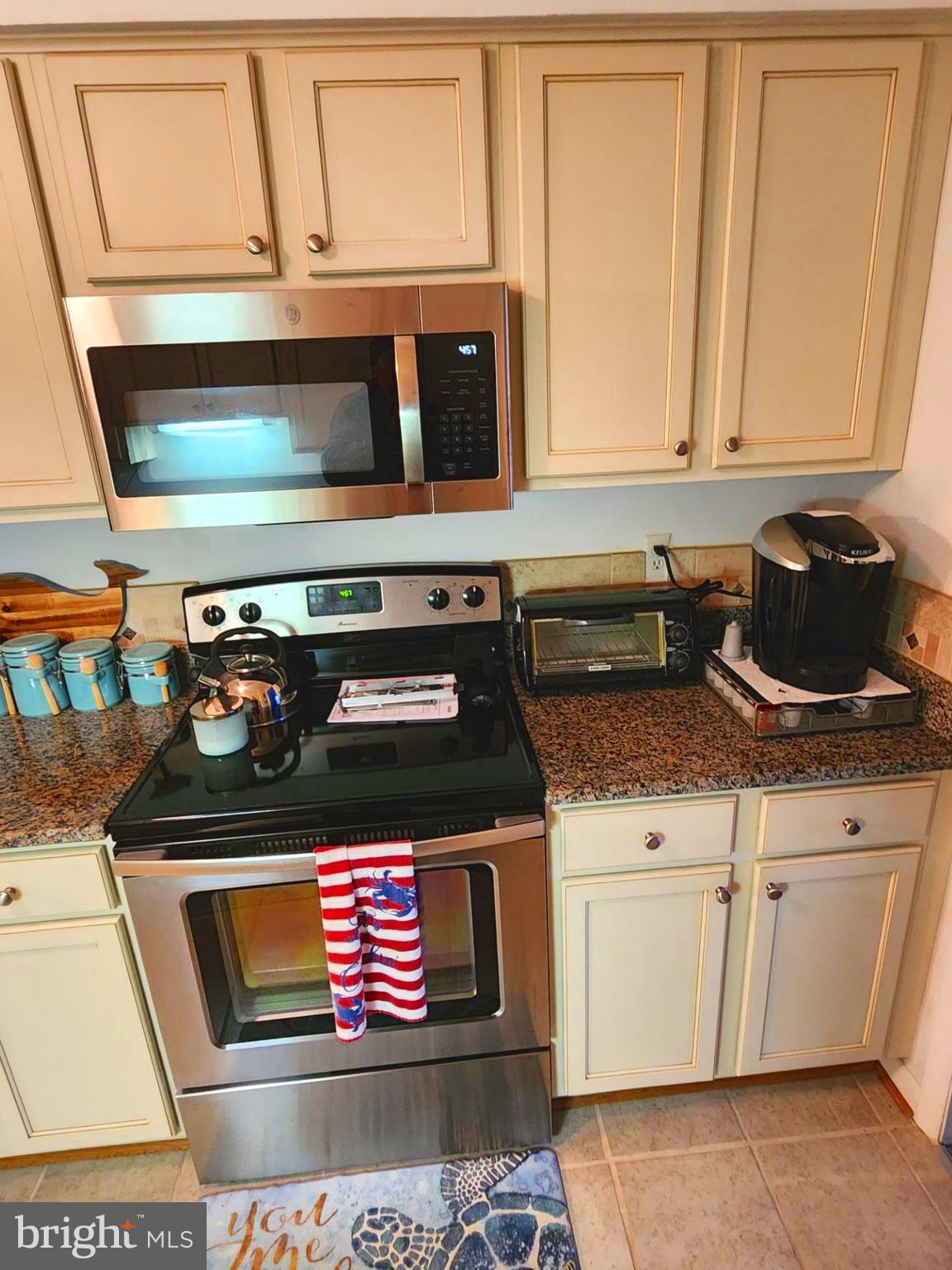 615 Salt Spray Road, Unit 3A Ocean City, MD 21842 - Photo 12 of 23 a stove top oven sitting inside of a kitchen