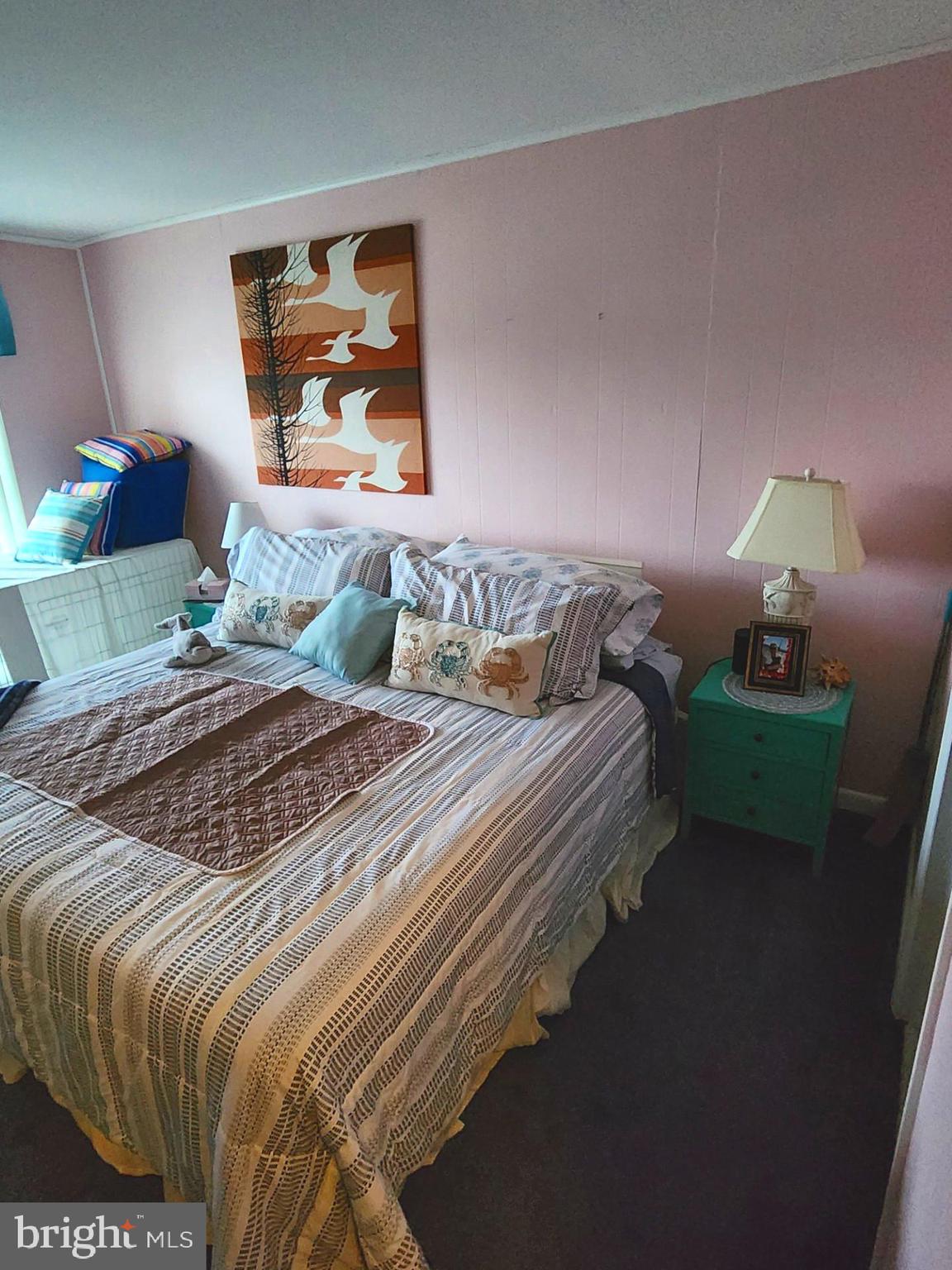 615 Salt Spray Road, Unit 3A Ocean City, MD 21842 - Photo 15 of 23 a bedroom with a bed and a painting on the wall